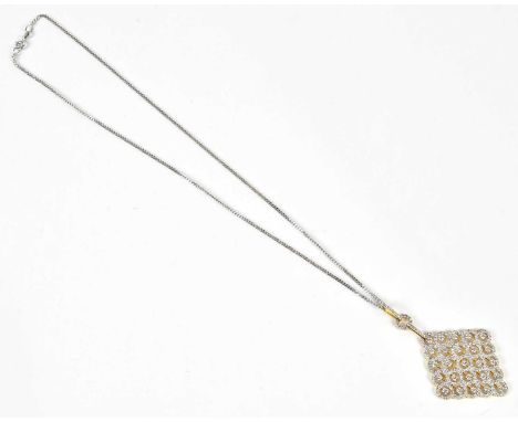An 18ct yellow and white gold pierced diamond set lozenge shaped pendant, suspended on a 9ct white gold chain, length of chai