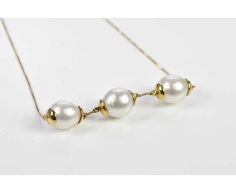 An 18ct yellow gold fine link chain suspending three large Baroque pearls, approx. 15.2g.
