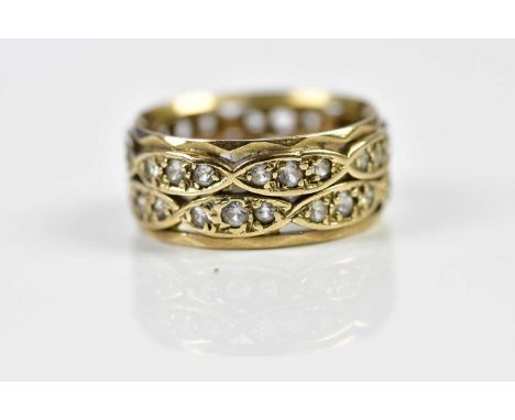 A yellow metal double row pierced dress ring, size K 1/2, approx. 4.26g.