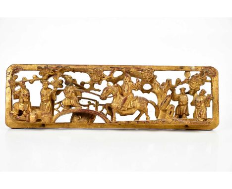 A Chinese giltwood carved panel depicting a figure on horseback beside further figures and prunus flowers, bears wax seal, 12