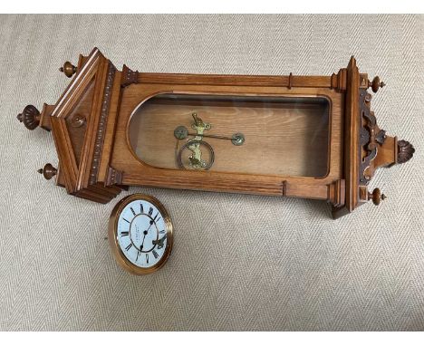 G. P. WEHLEN &amp; CO; an oak cased wall clock, the white enamel dial set with Roman numerals, height 110cm.Condition Report: