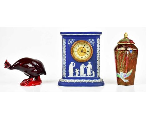 WEDGWOOD; an early 20th century blue jasperware mantel clock, relief decorated with figures and children and scrolling detail