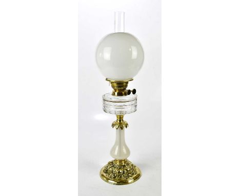 A cut glass two tier vessel oil lamp with fluted brass column sitting on a black round ceramic glazed base, with brass twin w