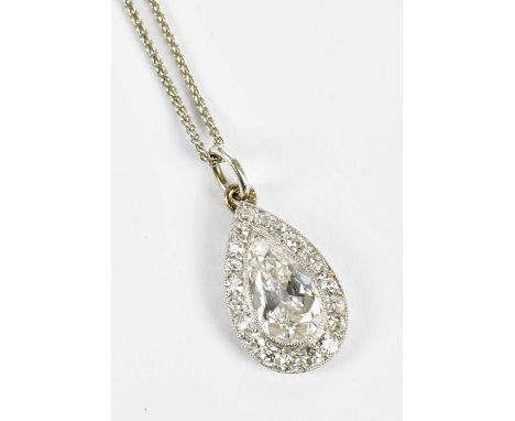 An 18ct white gold pear shaped diamond cluster pendant, the central stone weighing approx. 2cts within a border of round bril