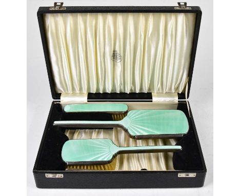 DAVID, MOSS &amp; CO; a cased George VI hallmarked silver and guilloche enamel three piece dressing table set comprising mirr