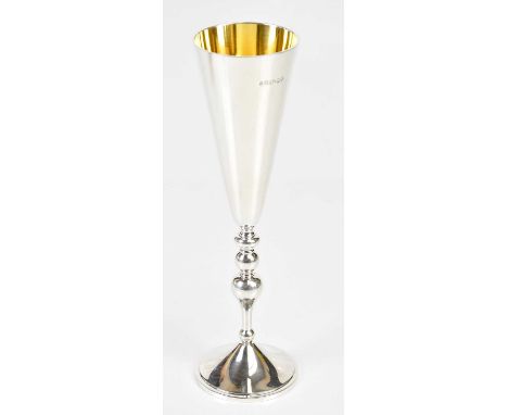 ASPREY &amp; GERRARD; an Elizabeth II Britannia standard hallmarked silver champagne flute with gilt interior, London 2000, h