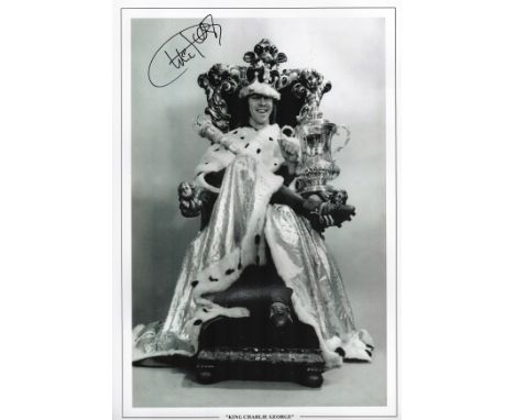 Football. Charlie George Signed 18x12 black and white photo. Photo shows George posing as a KING with crown etc, also holding