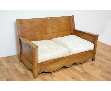 A contemporary hardwood two-seat sofa, the panelled back rest, flanked by shaped arm rests, removable cushions to the seat, w