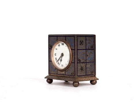 A miniature brass travel alarm clock, by Zenith Watch Co. with blue enamel decoration of fish and foliage, white enamel Roman