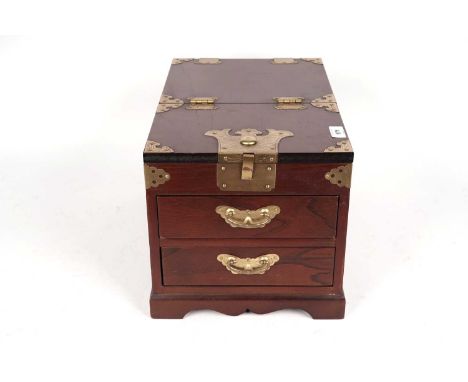 An Oriental mahogany jewellery box, with brass handles, mounts, and hinges, the lid folding up to reveal a mirror, 24 x 37 x 