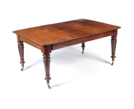 A Victorian mahogany extending dining table, the rounded rectangular top opening to receive an additional leaf, raised on rin