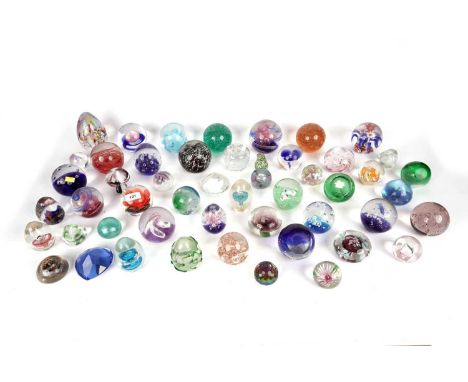 A selection of decorative glass paperweights, of various sizes, including: two Caithness ‘Moon Crystal’; a Caithness ‘Pixie’;