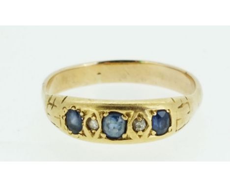 A gold ring set three sapphires and two chip diamonds, size N