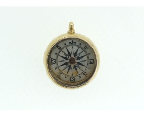 An 18 carat gold framed compass charm 0 8g a/f