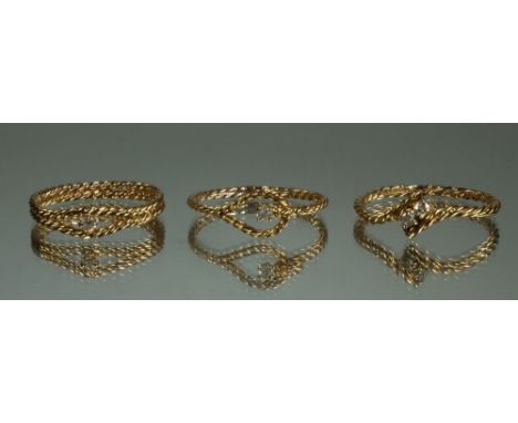 Three 14 carat gold spiral twist rings set diamonds, size k, total 3.2g