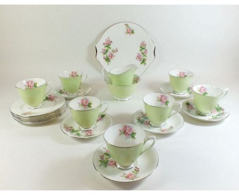A Royal Albert tea service in apple green and painted blossom to interior compiling of 7 cups, 6 saucers, 6 tea plates, cake 
