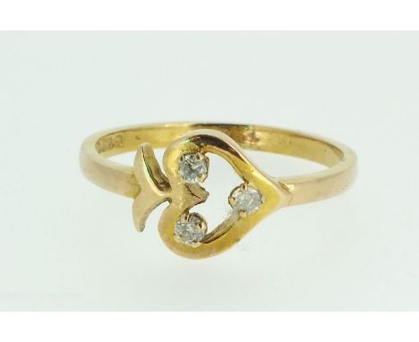 A 15ct gold ring with heart and arrow motif set three diamonds, size L 1/2, 2g