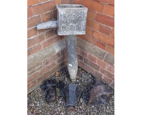 An early 19th century large lead section of guttering pipe dated 1808 and three later cast iron down pipe heads