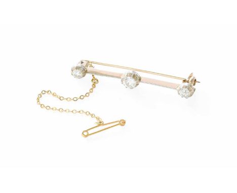 A Diamond Three Stone Bar Brooch, the graduated old cut diamonds in white collet settings, on a knife edge bar, total estimat