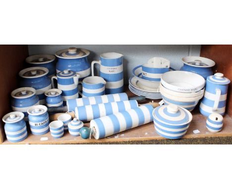 A collection of Cornish ware including jars and covers, rolling pins, jugs, plates etc (one shelf)Crazing throughout and some