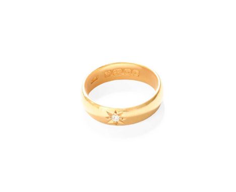 A 22 Carat Gold Diamond Solitaire Ring, the old cut diamond in a yellow star setting, to a plain polished shank, finger size 