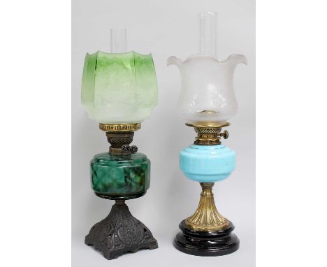 Four Various Oil Lamps, comprising a brass oil lamp with amber glass reservoir and white opaque glass shade; a brass oil lamp