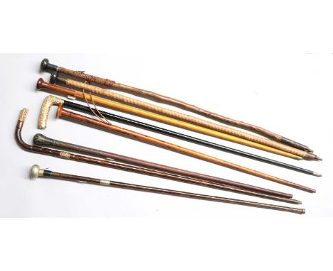 A Collection of 19th Century and Later Walking Sticks and Canes, including a partridge wood cane having a time piece handle w