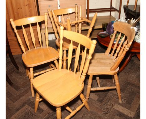 Set of four light beech Windsor style slat back dining chairs and a similar spindle back chair 