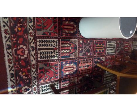 A Bautiari carpet with central tile design contained by many borders. 310cm X 207cm 