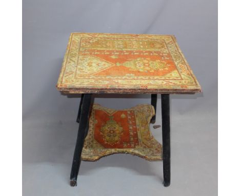 A two tier gypsy table having tapestry coverings. 