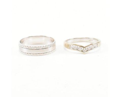 Two hallmarked 9ct white gold rings. The wishbone ring of chevron form set with round cut white stones, hallmarked for London