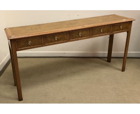 A burr walnut side table in the Georgian manner, the sectional top feathered and cross banded within a moulded edge over five