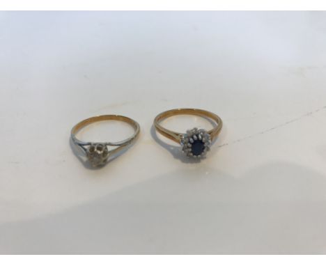 An 18 carat gold mounted oval cut sapphire dress ring within a band of twelve small diamonds, setting approx. 0.7 cm x 0.6 cm