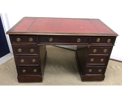 A Victorian mahogany double pedestal desk, the red leather tooled and gilded writing surface within a moulded edge over three