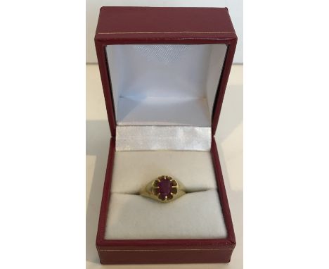 An un-marked yellow metal oval cut ruby solitaire ring, 5.7 g, size M