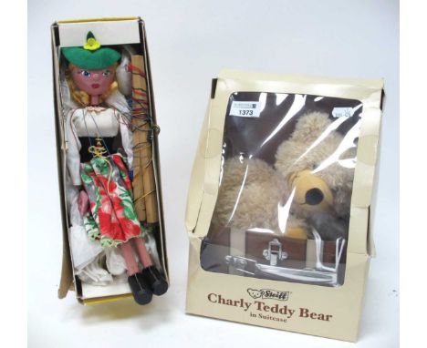 A Steiff 'Charley teddy bear in suitcase' together with a Pelham puppet 'Mitzi Girl' both in original boxes. (2)