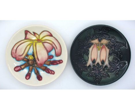 Two Moorcroft Pin Dishes, 'Cluny trees' pattern date cypher for 1994 and 'Frangipani' pattern dated 99, both12cm diameter. (2