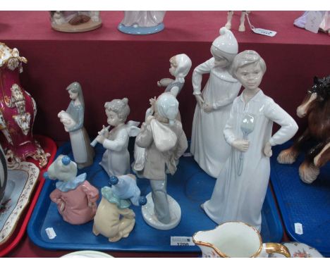 Lladro and Nao figurines to include girl with torn nightgown, boy with fly swatter, pair of small jesters and an angel with f