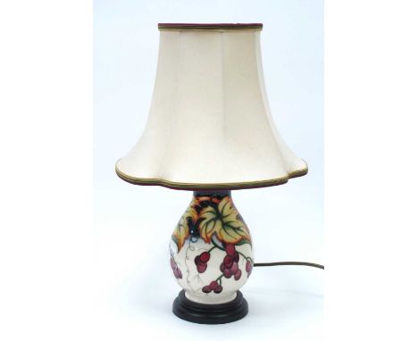 A Moorcroft table lamp decorated in the 'Anna Lily' pattern designed by Nicola Slaney, complete with original Moorcroft shade