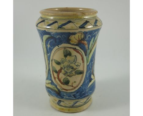An Italian maiolica albarello or pharmacy jar, waisted cylindrical form, painted with a central floral cartouche, 17cm high