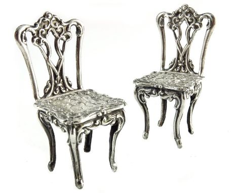 A pair of Elizabeth II miniature silver chairs, Richards and Knight, London 1970, Chippendale form, embossed in the Dutch sty