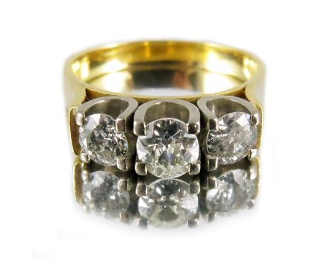 A three stone diamond ring, set in 18 carat gold, approximately 1.75 carat total weight, approx size M