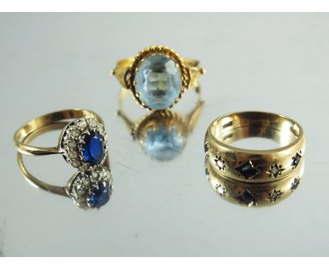 Three gold and gem set rings, including a sapphire and diamond five stone ring, an aquamarine and a blue and white stone clus