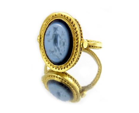 A Roman Nicolo intaglio ring, central hardstone cameo engraved with Venatores, set in high carat gold, with rope twist and be