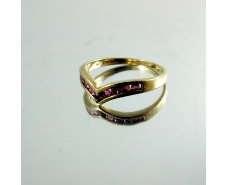 A 9 carat gold and ruby set ring, channel set, V form, approx. size J