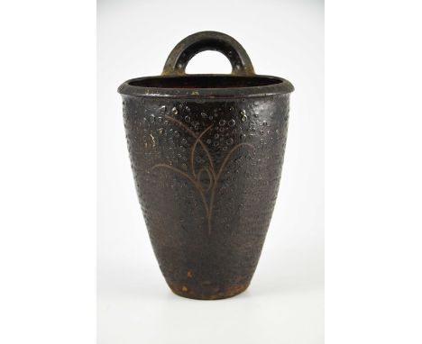 Michael Cardew for Winchcombe, a studio pottery hanging planter, incised stylised floral motif, burst bubble glaze, impressed