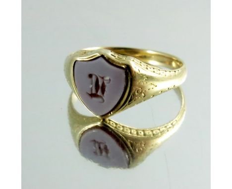 A childs cameo engraved gold signet ring, shield shaped, intaglio engraved with initial