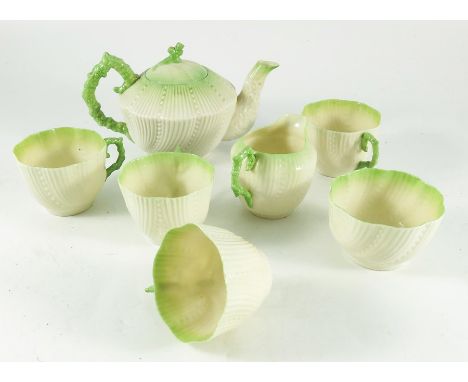 A Belleek Blarney relief moulded nautical tea set, including teapot, jug and bowl, with four cups, angled ovoid form with wry