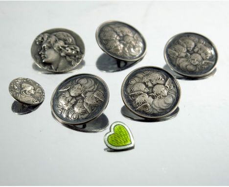 A collection of Arts and Crafts silver and white metal buttons, including four Reynolds Angels buttons, two Art Nouveau style