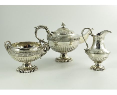 A Victorian silver plated three piece tea set, circa 1870, half fluted and reeded pedestal ovoid form, with etched and engrav